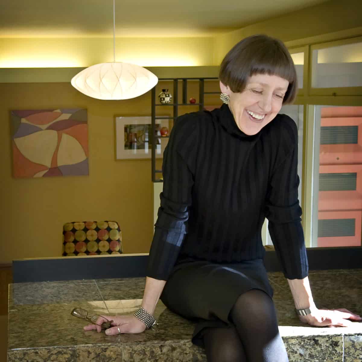 Monica Monaghan-Milstein sitting on counter